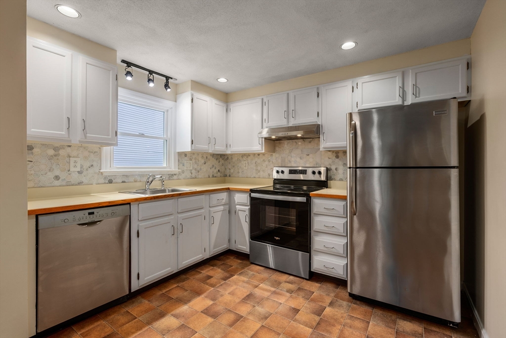 5 Old Central Turnpike Framingham, MA 01702 - Photo 2 of 32 a kitchen with a refrigerator stove and sink