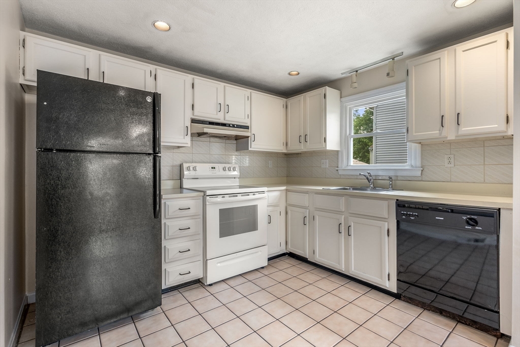 5 Old Central Turnpike Framingham, MA 01702 - Photo 21 of 32 a kitchen with white cabinets and white stainless steel appliances