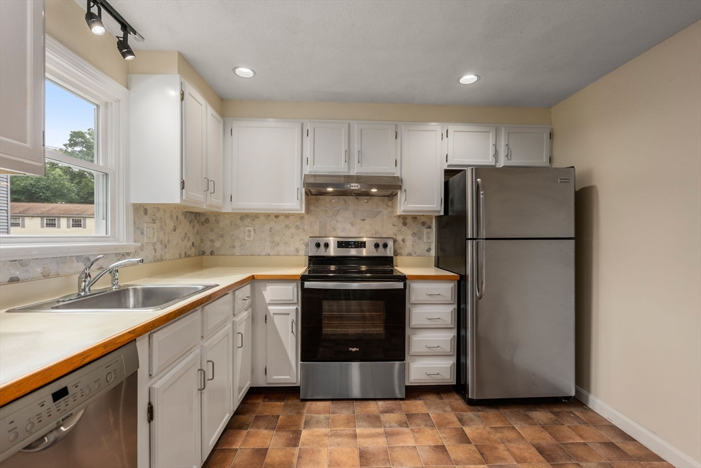 5 Old Central Turnpike Framingham, MA 01702 - Photo 3 of 32 a kitchen with a refrigerator sink and stove
