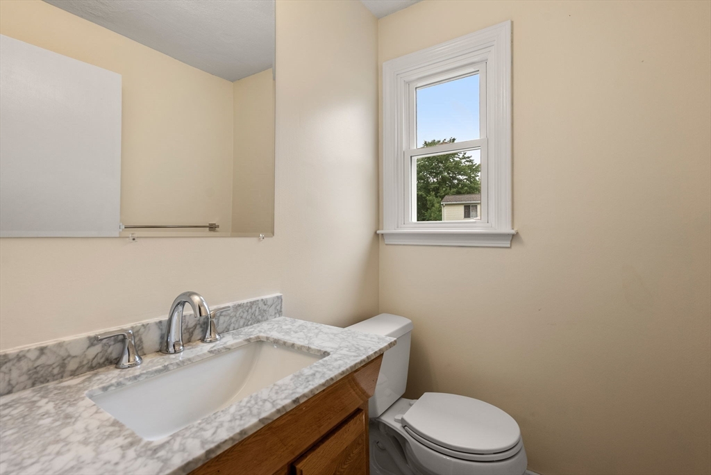5 Old Central Turnpike Framingham, MA 01702 - Photo 8 of 32 a bathroom with a granite countertop toilet sink and mirror