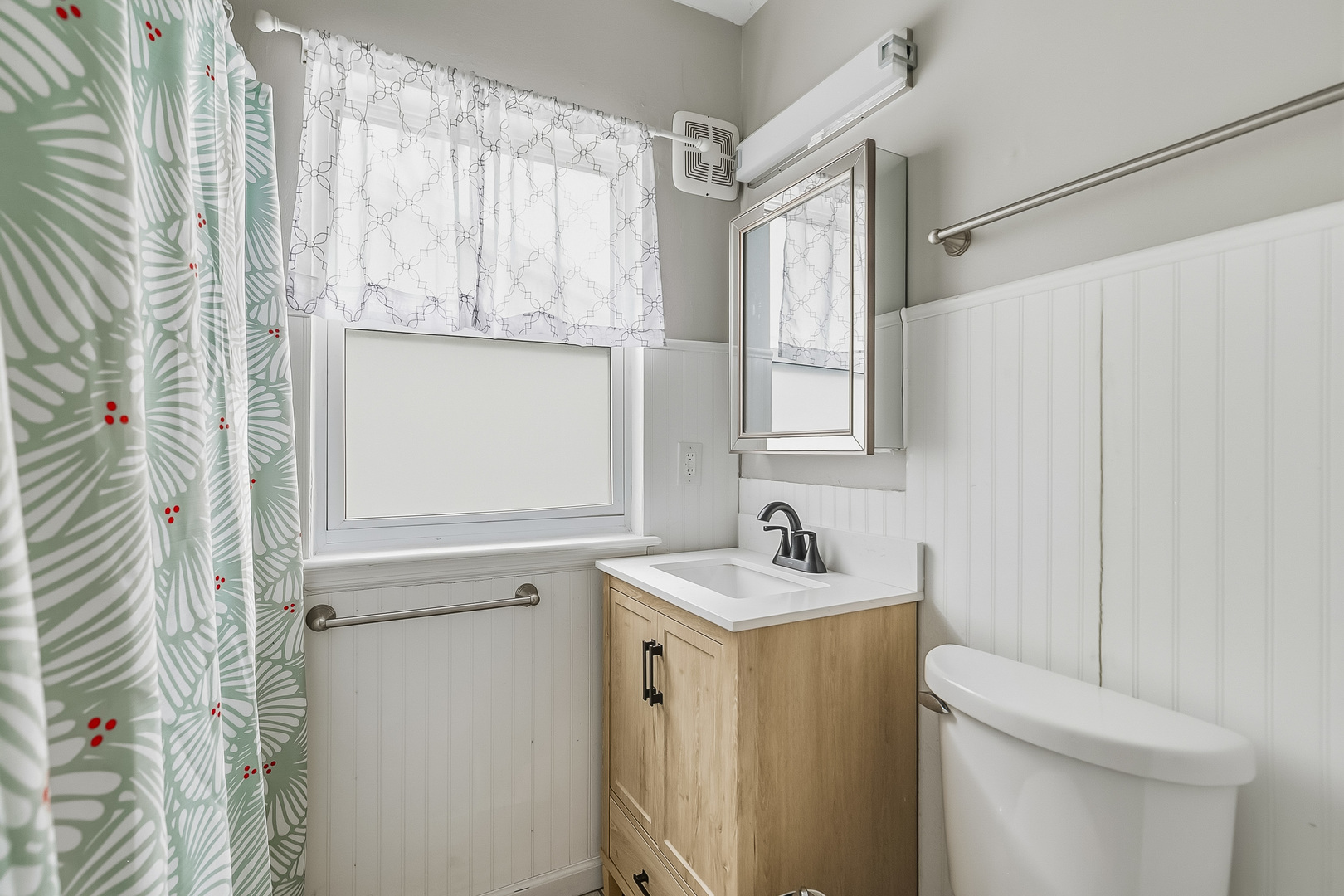 3237 12th Street Rock Island, IL 61201 - Photo 11 of 36 a bathroom with a sink a toilet and a mirror