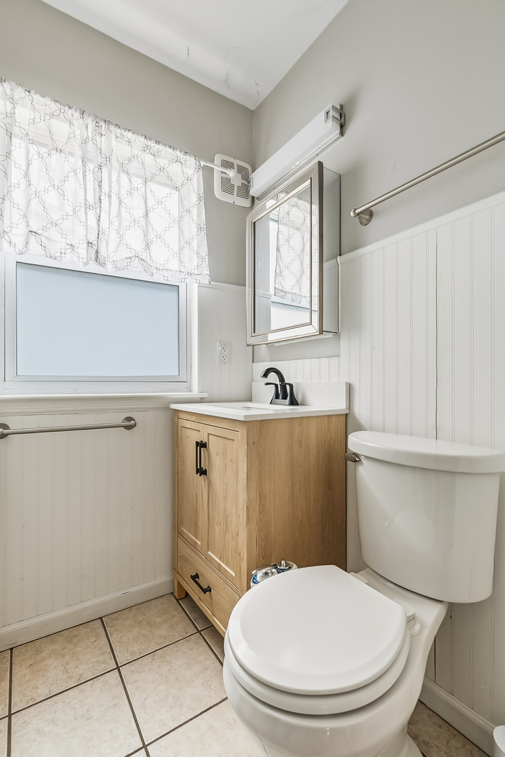 3237 12th Street Rock Island, IL 61201 - Photo 12 of 36 a bathroom with a sink a toilet and a mirror