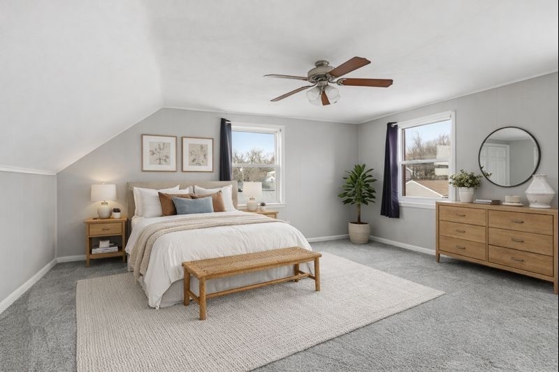 3237 12th Street Rock Island, IL 61201 - Photo 14 of 36 a spacious bedroom with a bed a dresser and potted plants
