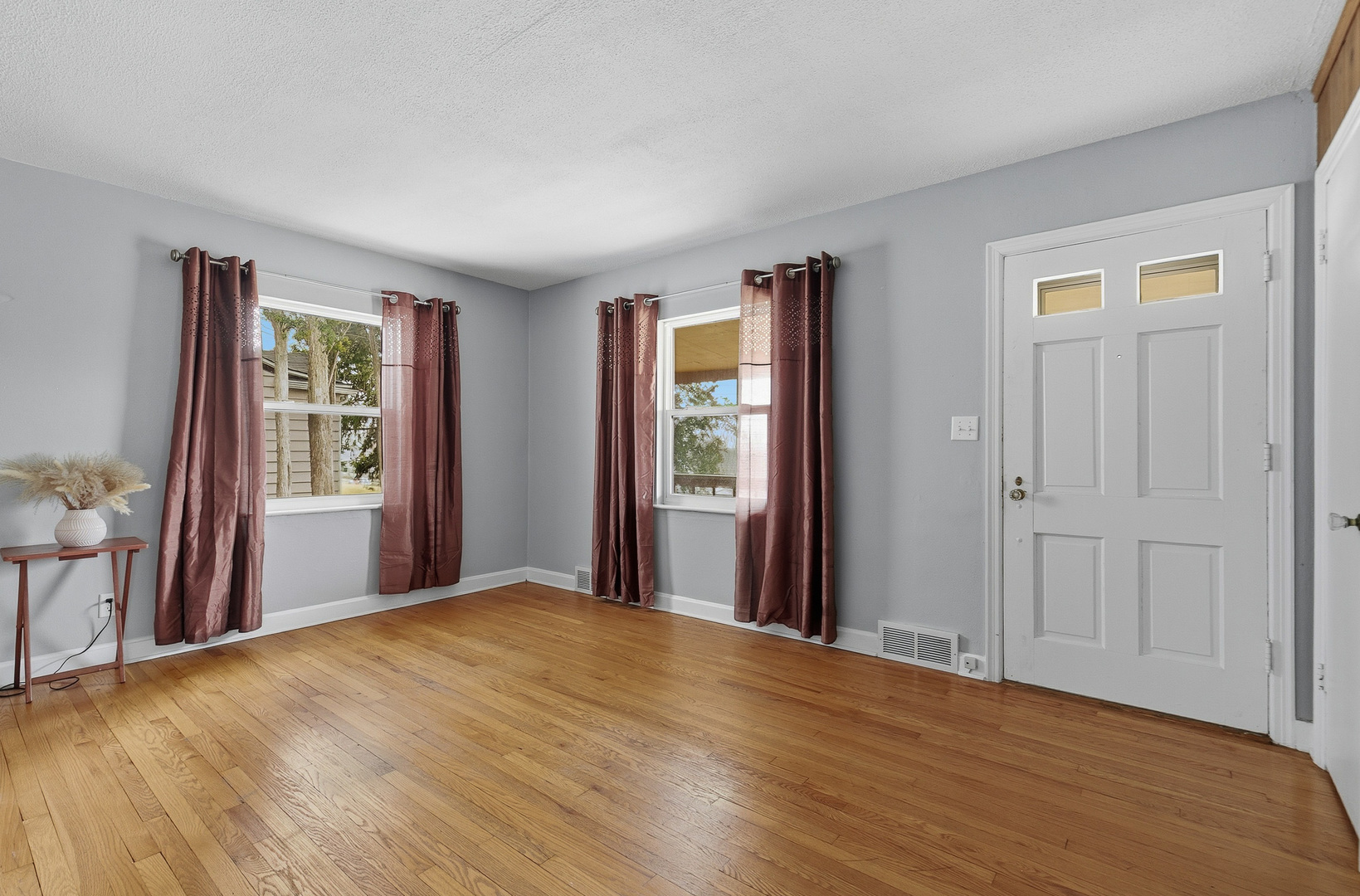 3237 12th Street Rock Island, IL 61201 - Photo 2 of 36 a view of an empty room with wooden floor and a window