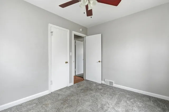 an empty room with windows and closet