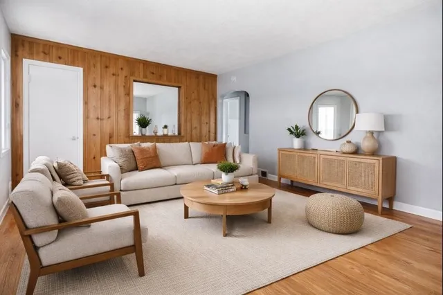 a living room with furniture and a wooden floor