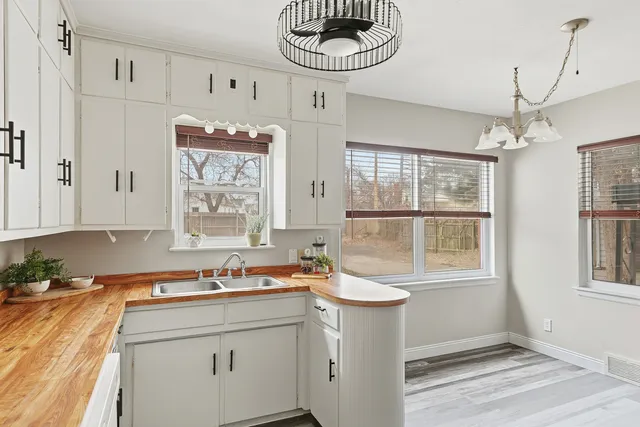 a bathroom with a sink a mirror and a window