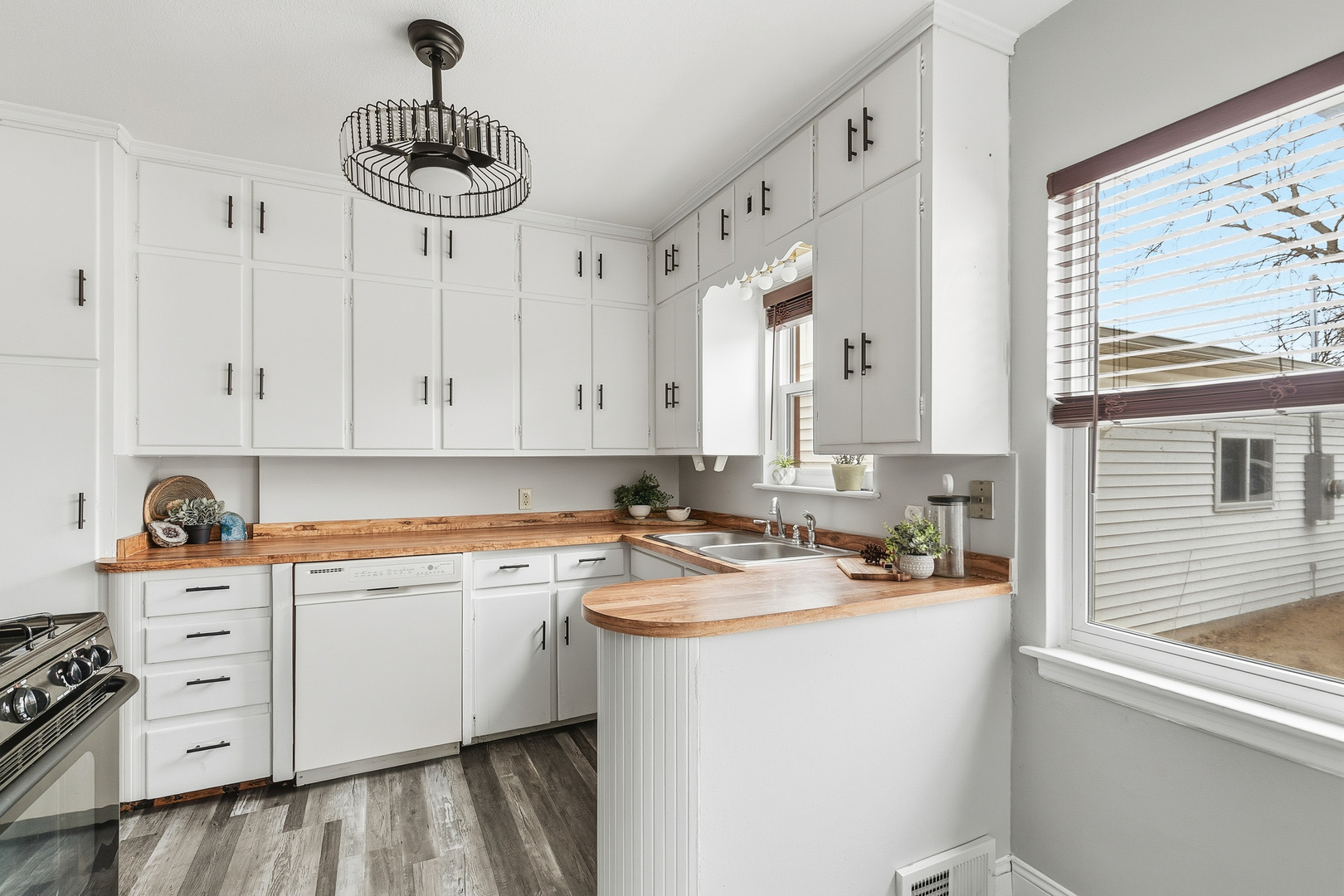 3237 12th Street Rock Island, IL 61201 - Photo 8 of 36 a kitchen with a white cabinets and chandelier