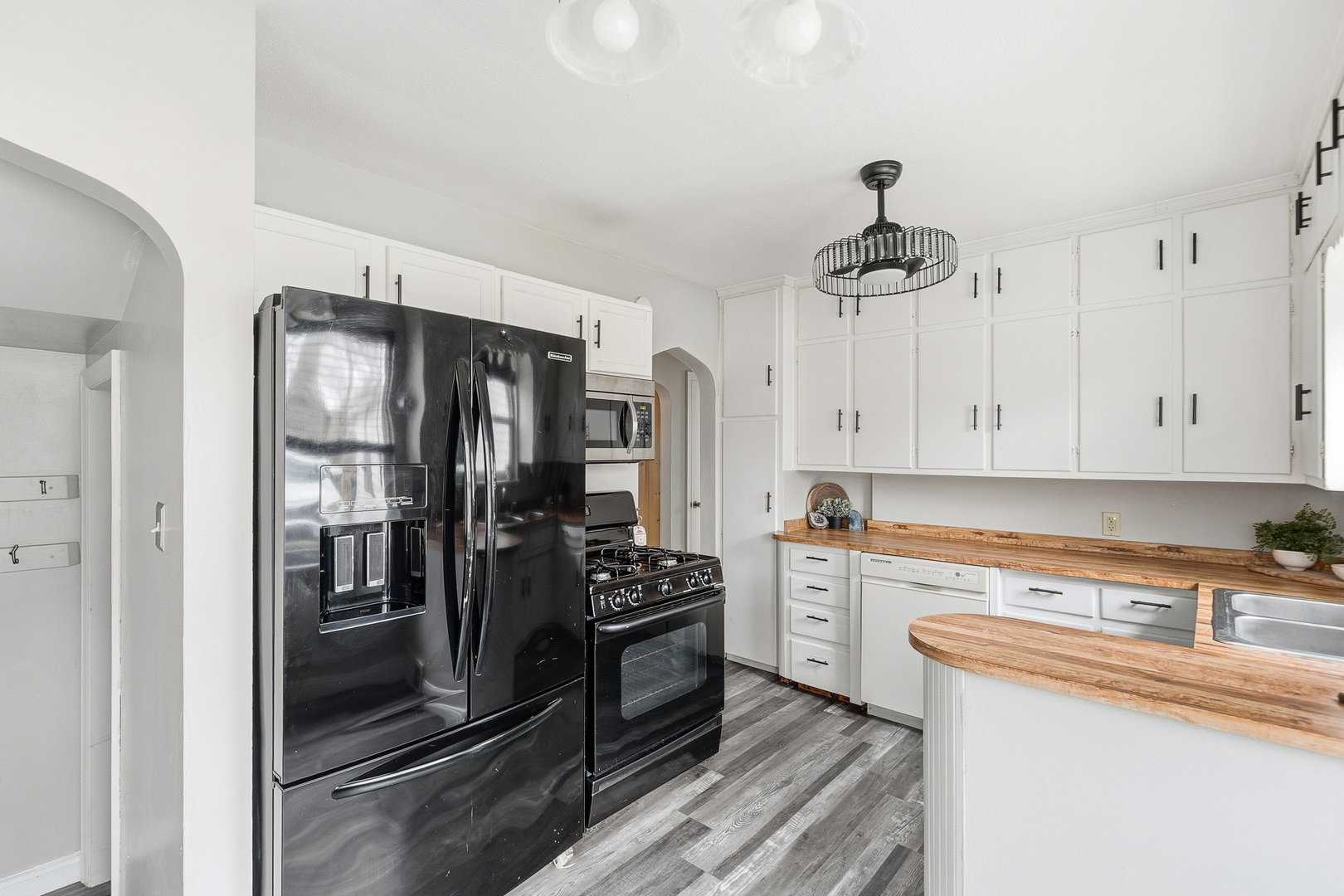 3237 12th Street Rock Island, IL 61201 - Photo 9 of 36 a kitchen with a refrigerator and a stove top oven