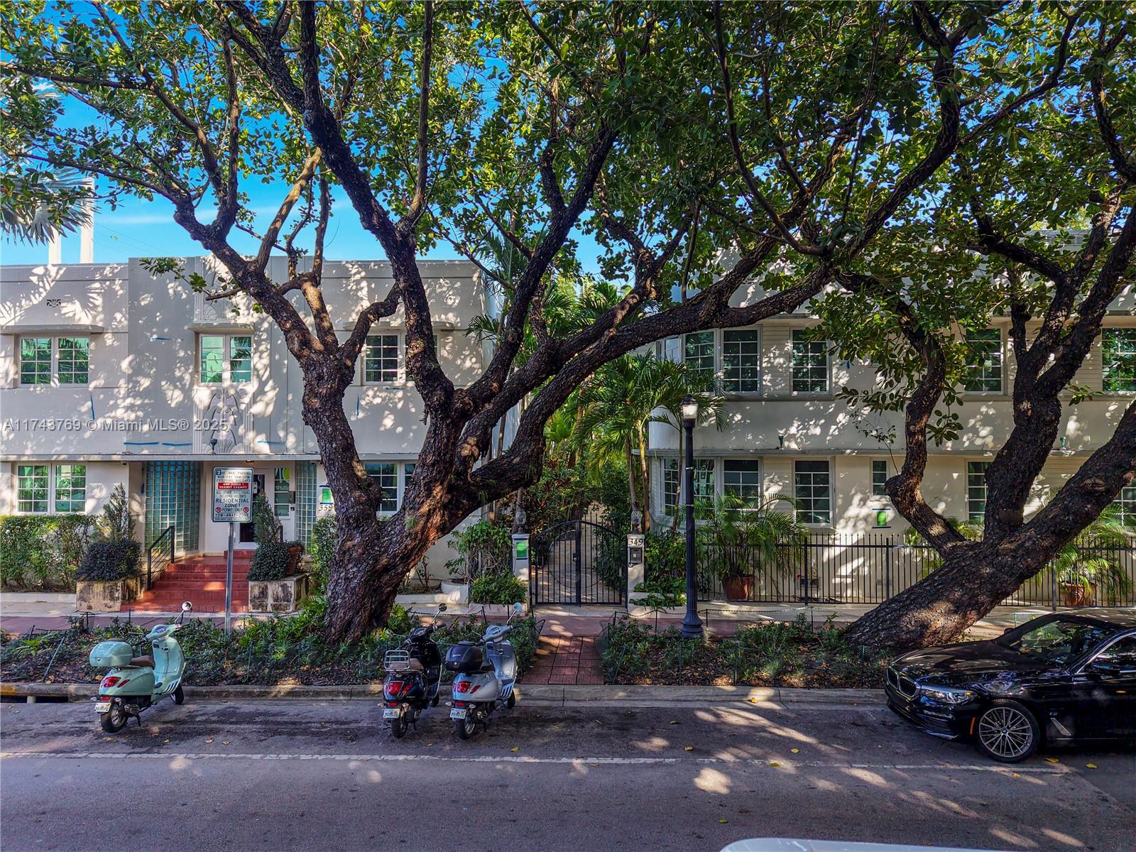 349 Meridian Avenue, Unit B207 Miami Beach, FL 33139 - Photo 1 of 34 a couple of cars parked in front of a house