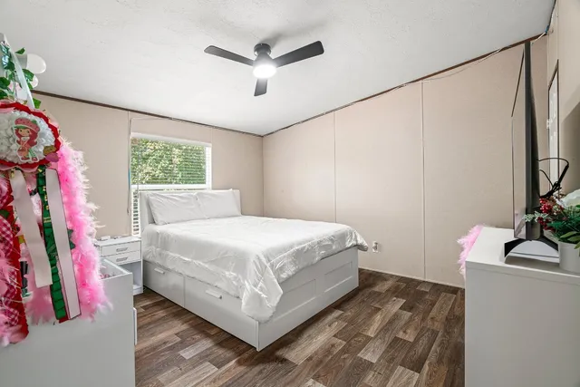 a bedroom with a bed and a flat screen tv