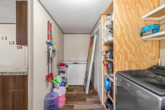 a view of hallway with wooden floor and stairs
