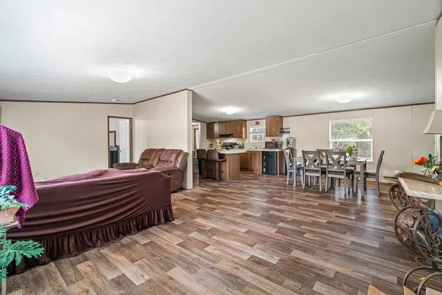 a room with lots of furniture and a wooden floor