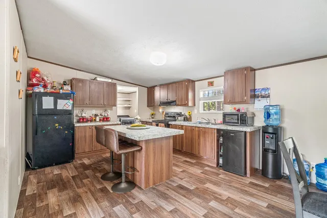 a kitchen with a sink refrigerator and cabinets