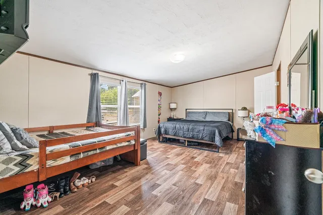 a bedroom with furniture and a large window