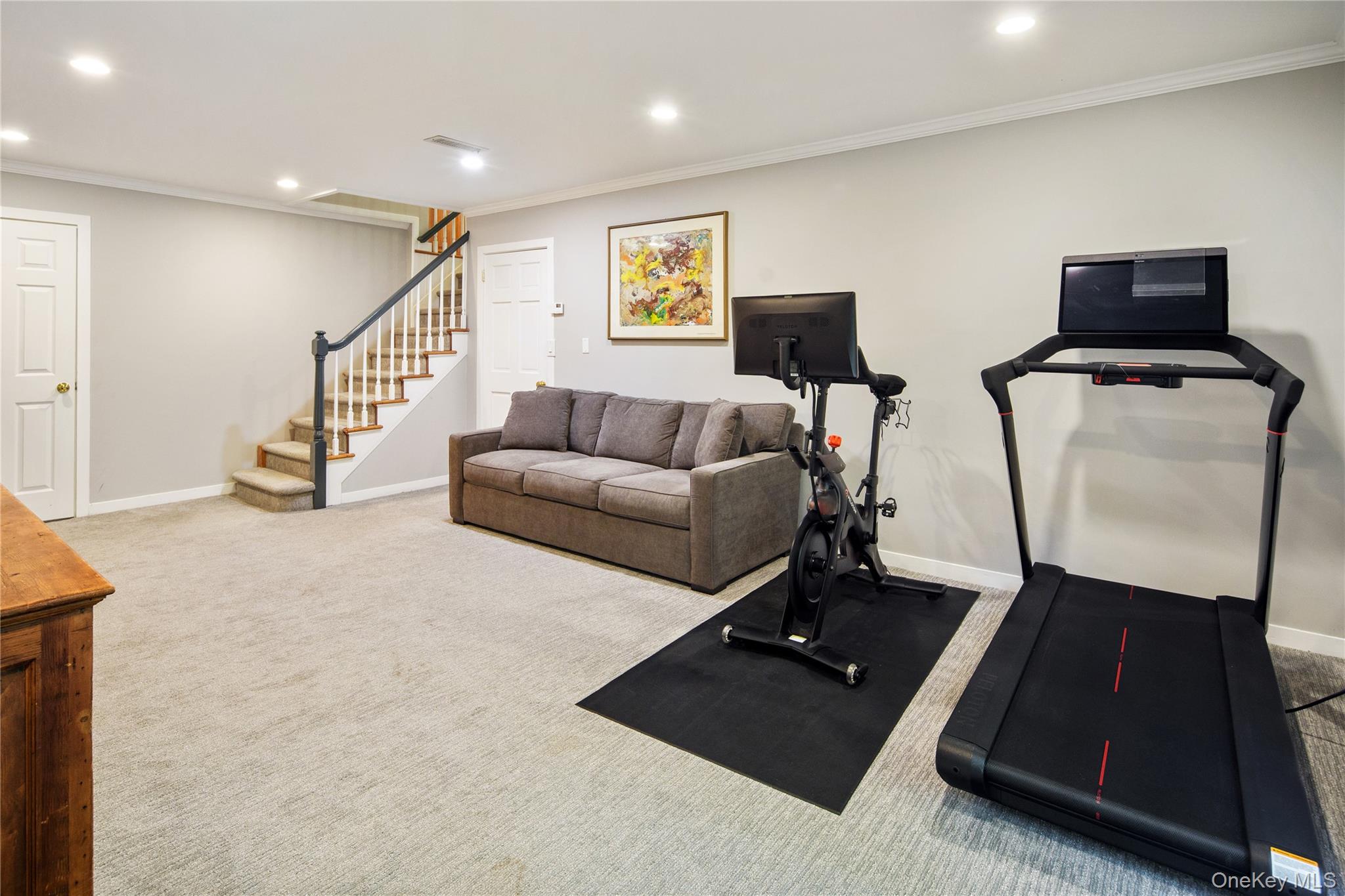 105 Cross Ridge Road Chappaqua, NY 10514 - Photo 36 of 43 The lower level offers a large playroom/rec room with crown molding, recessed lighting and sliding glass doors to the lower patio, a home office, powder room and storage/mechanical room, a large fully outfitted mudroom and generous sized two car garage.