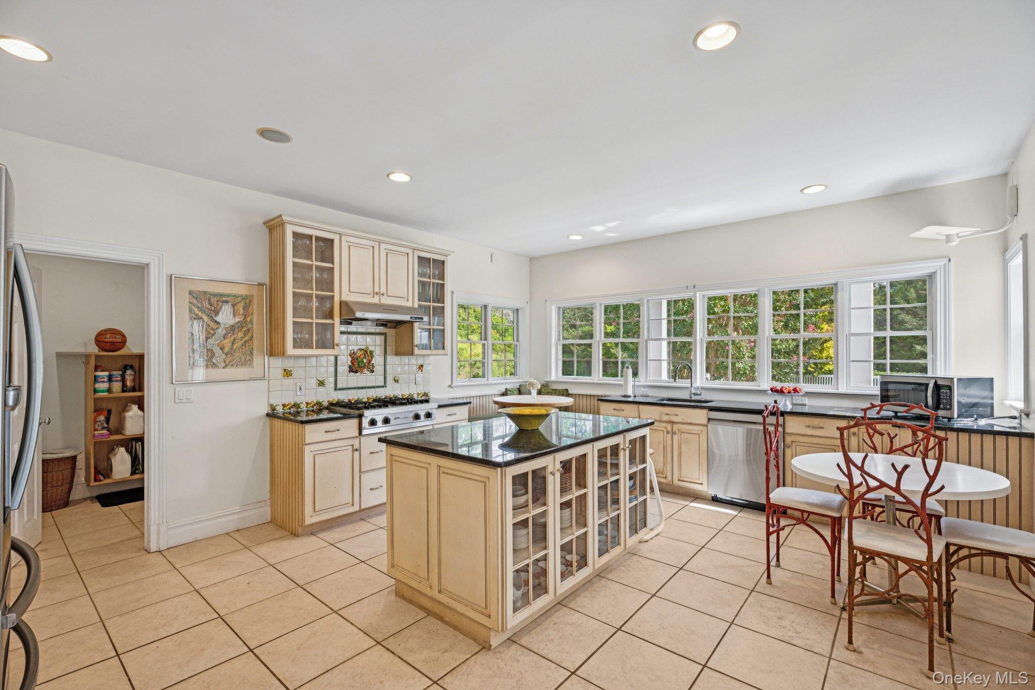 12 Laila Lane Remsenburg, NY 11960 - Photo 14 of 50 a kitchen with stainless steel appliances granite countertop a stove a sink and a refrigerator