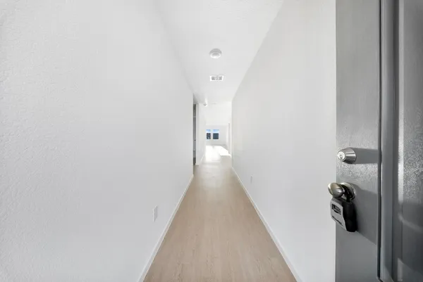 a view of a hallway with a white walls