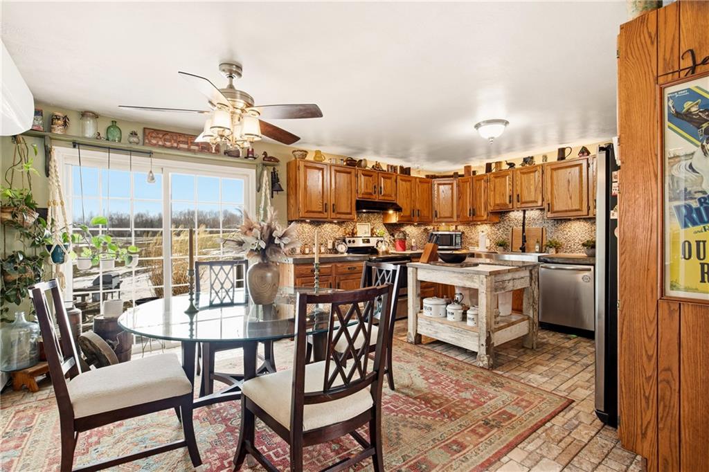 599 Brown Road Acme, PA 15610 - Photo 13 of 37 a kitchen with a table chairs stove and cabinets