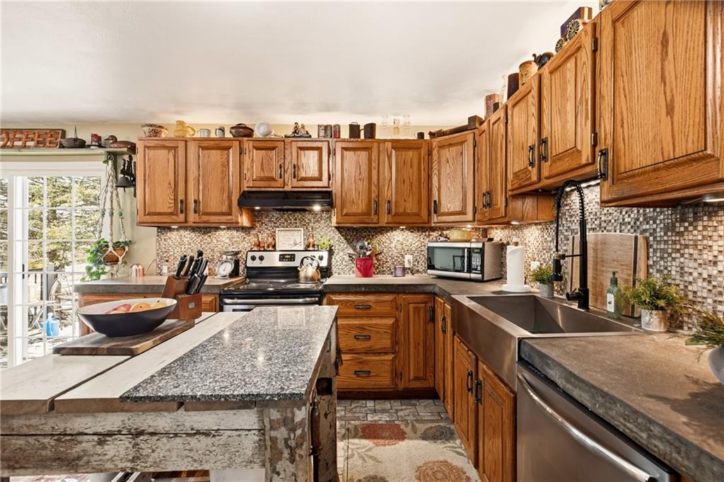 599 Brown Road Acme, PA 15610 - Photo 16 of 37 a kitchen with stainless steel appliances granite countertop a sink a stove and a microwave