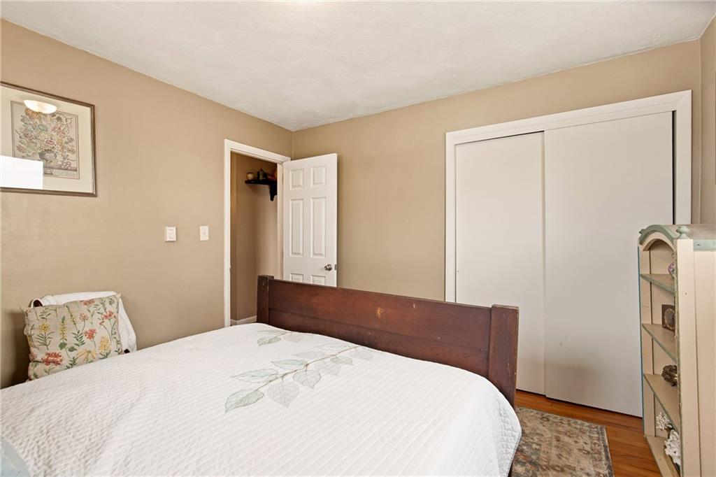 599 Brown Road Acme, PA 15610 - Photo 20 of 37 a bedroom with a bed and wooden floor