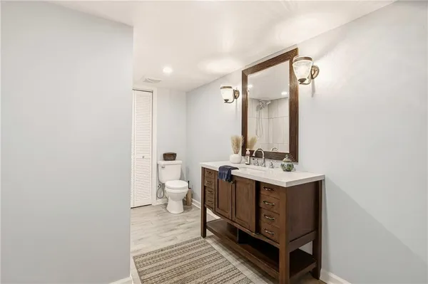 a bathroom with a sink a toilet and shower