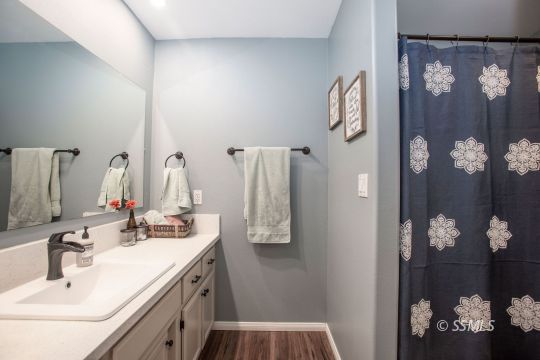 421 Christopher Court Ridgecrest, CA 93555 - Photo 17 of 50 a bathroom with a sink vanity and mirror