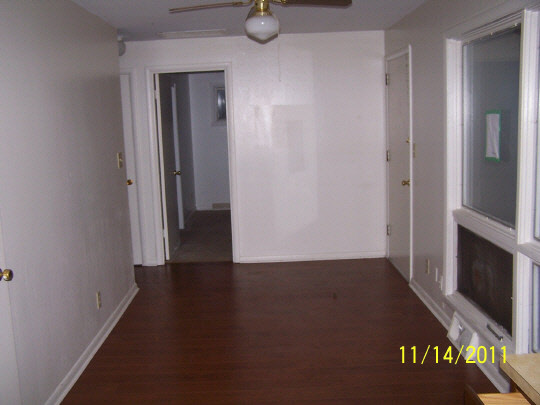 4705 Highcrest Road Rockford, IL 61107 - Photo 4 of 8 a view of an empty room with wooden floor and a window