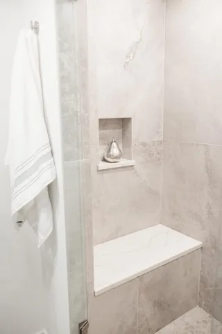 a bathroom with bathtub and shower