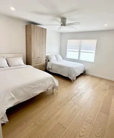 a bedroom with a bed and a night stand