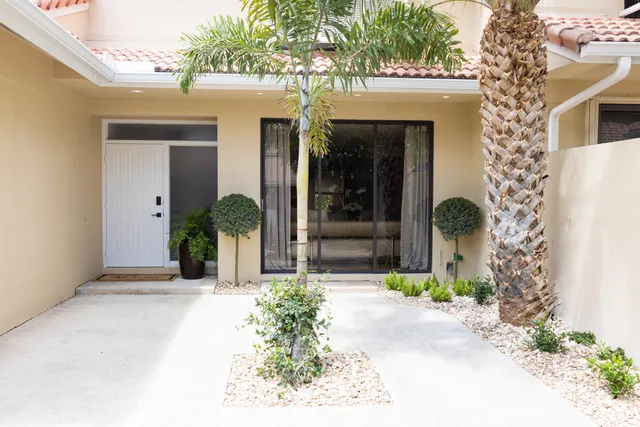 front view of a house with potted plants