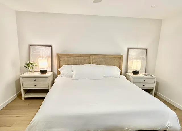 a large white bed in a white room