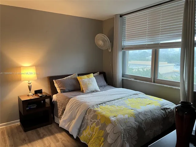 a bedroom with a bed and window