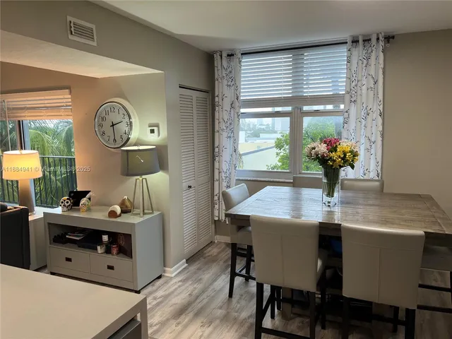 a view of a dining room with furniture window and wooden floor