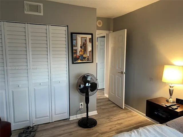 a bedroom with a bed and a lamp on table