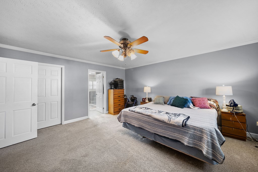 4300 Green Road Ellaville, GA 31806 - Photo 13 of 41 a bedroom with a bed and a chandelier