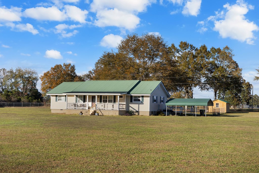 4300 Green Road Ellaville, GA 31806 - Photo 2 of 41 a front view of a house with a garden and trees