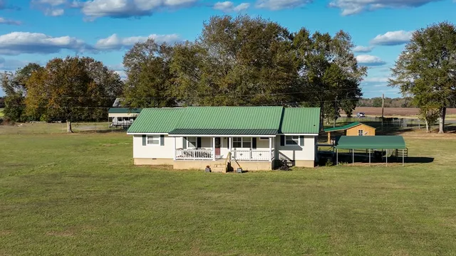 a view of a green field with sitting area
