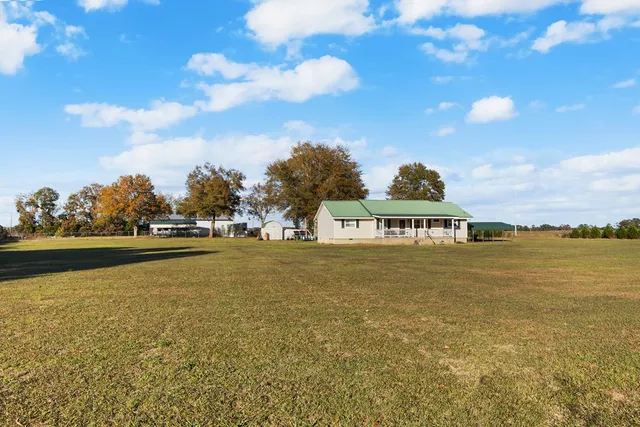 a front view of a house with a big yard