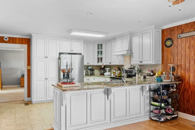 a kitchen with refrigerator and cabinets