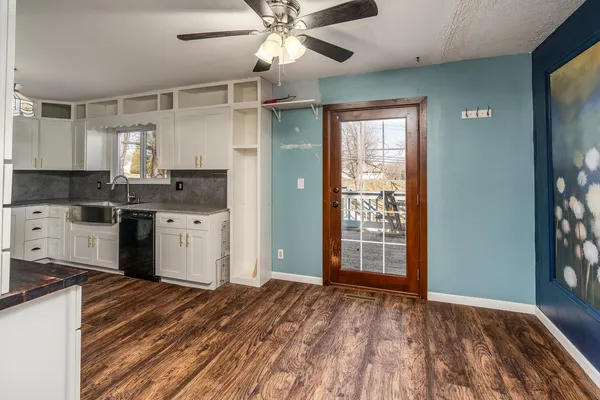 a kitchen with stainless steel appliances granite countertop a stove cabinets and wooden floor