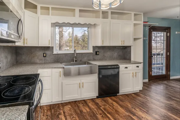 a kitchen with stainless steel appliances granite countertop a stove and a sink