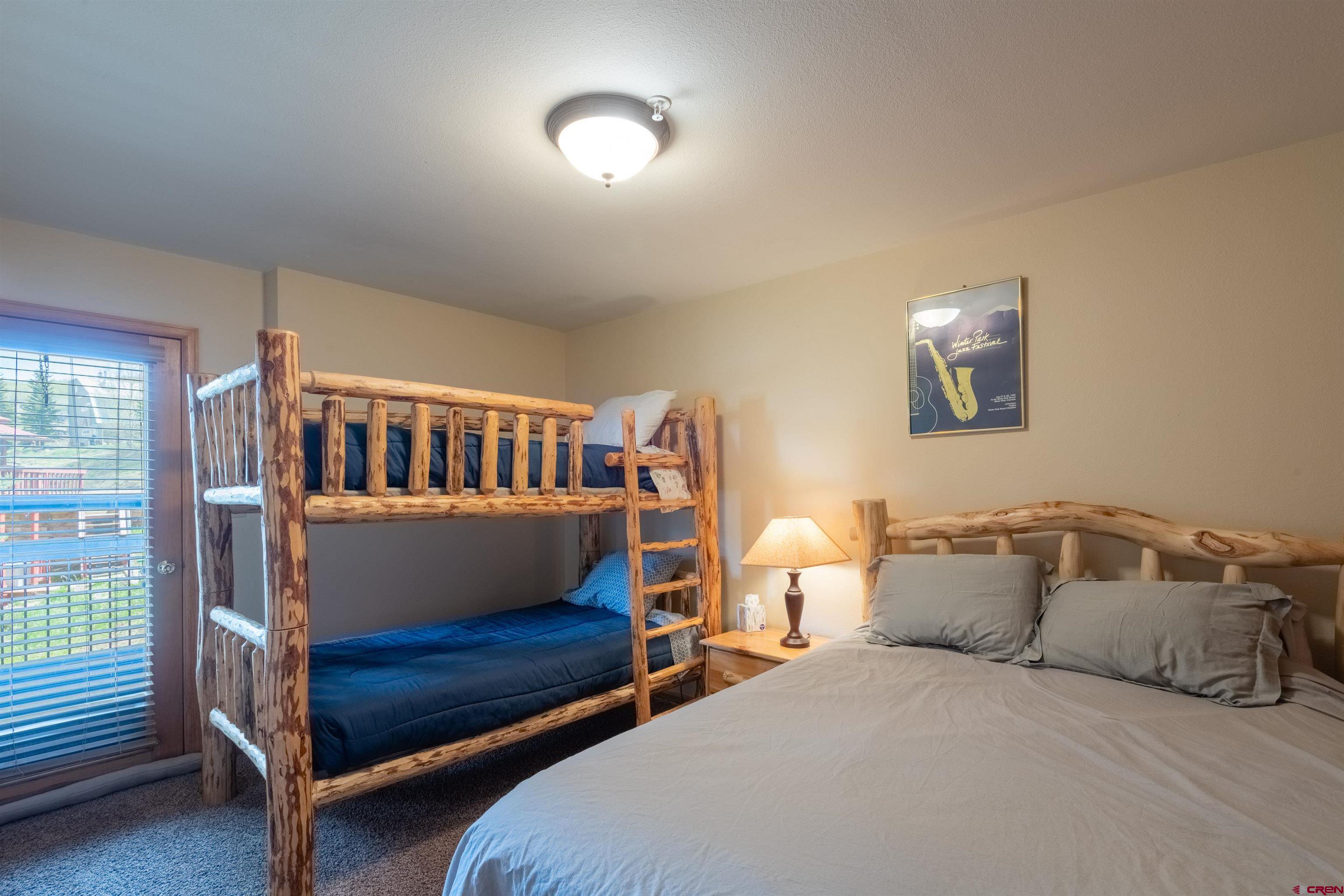 33 Castle Road, Unit 3 Crested Butte, CO 81225 - Photo 16 of 34 a bedroom with a bed and a baby crib