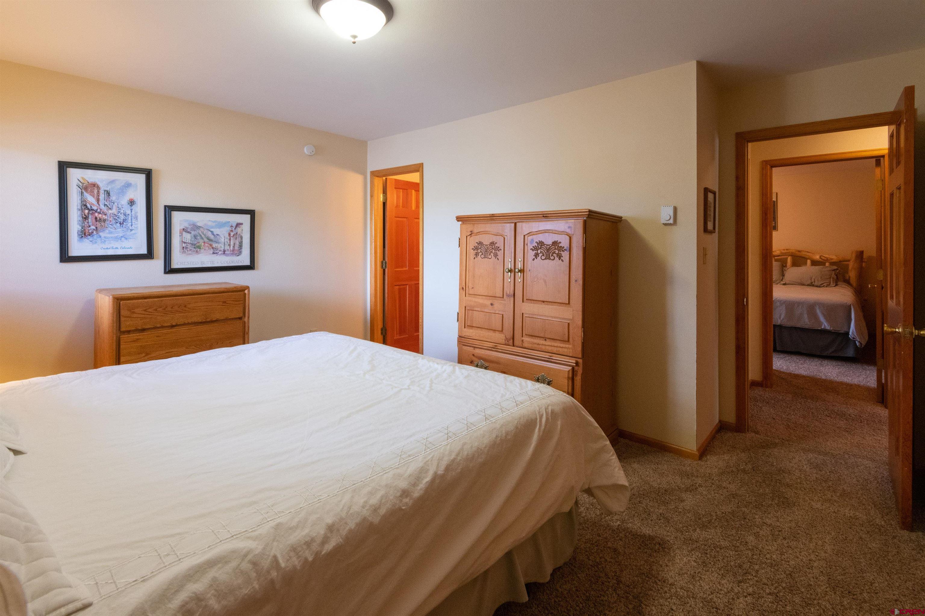 33 Castle Road, Unit 3 Crested Butte, CO 81225 - Photo 22 of 34 a bedroom with a bed and a dresser