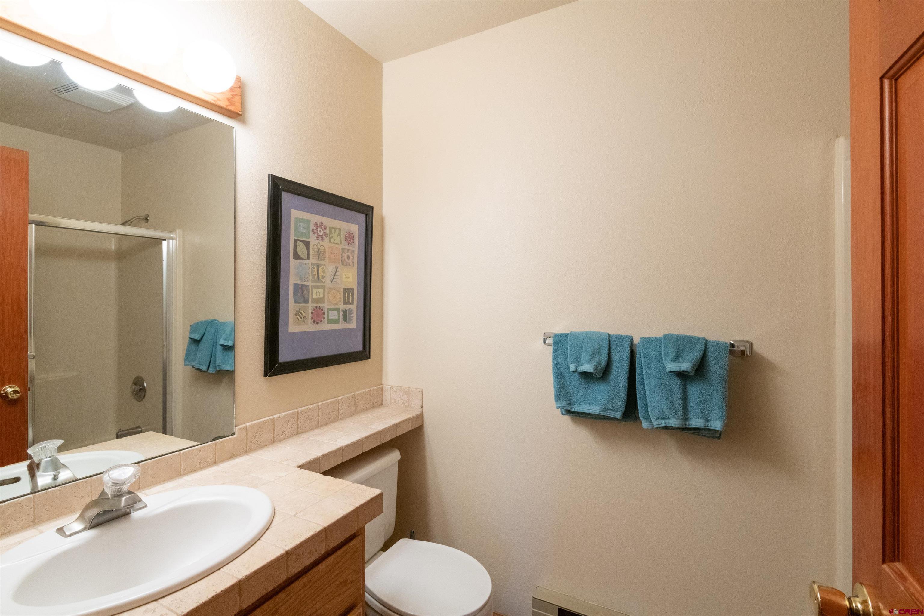 33 Castle Road, Unit 3 Crested Butte, CO 81225 - Photo 25 of 34 a bathroom with a toilet sink and mirror