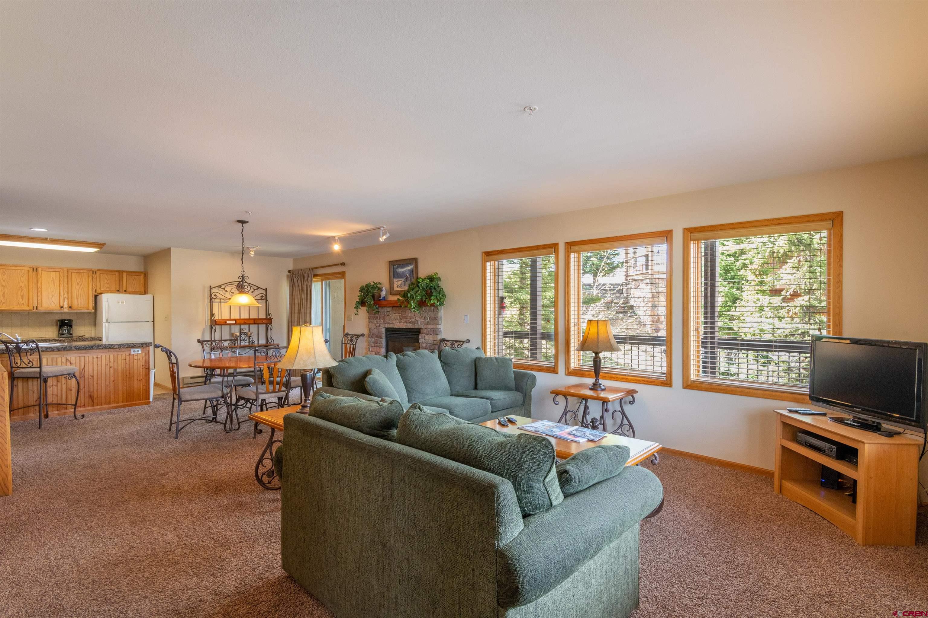 33 Castle Road, Unit 3 Crested Butte, CO 81225 - Photo 4 of 34 a living room with furniture and a flat screen tv