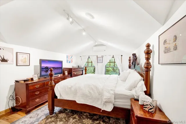 a bedroom with a bed and a large window