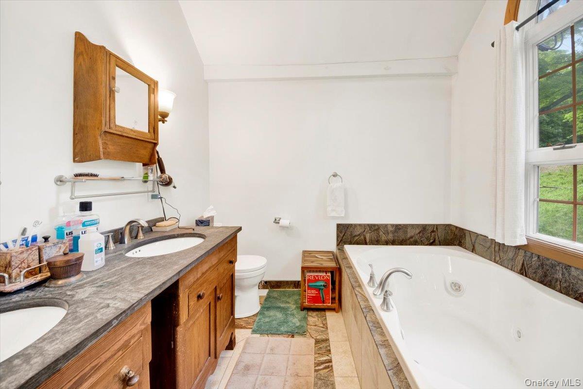 161 Goldens Bridge Road Katonah, NY 10536 - Photo 22 of 44 a bathroom with a granite countertop sink and a mirror