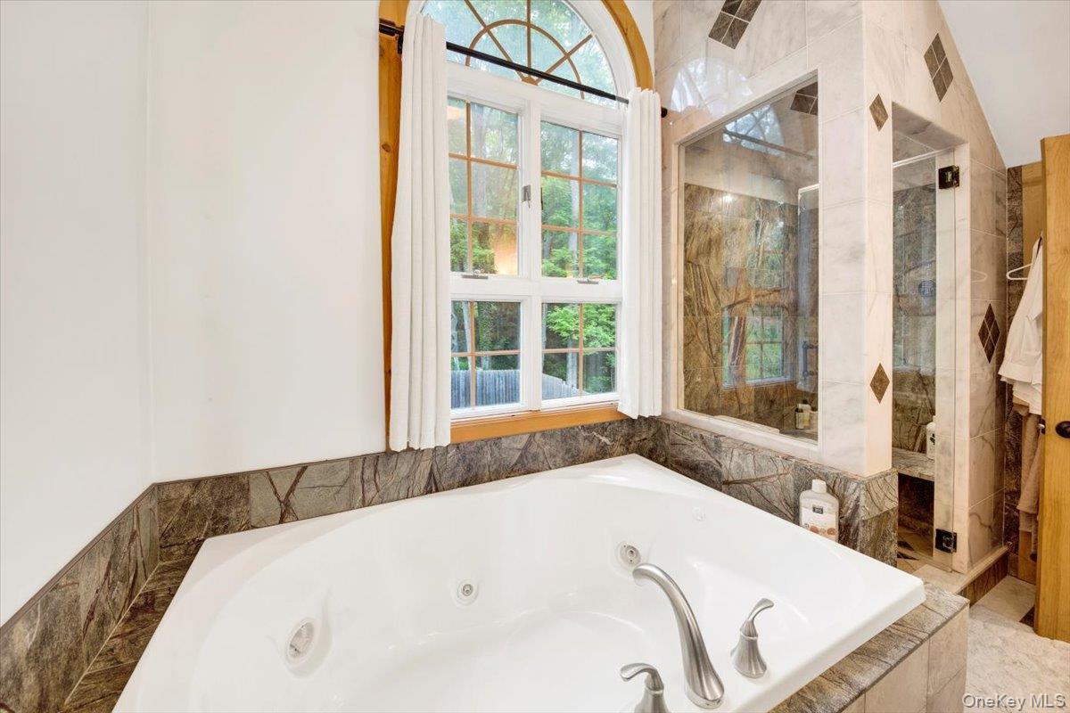 161 Goldens Bridge Road Katonah, NY 10536 - Photo 23 of 44 a bathroom with a tub and a window