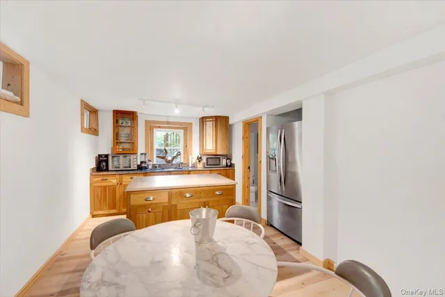 a bathroom with a sink and mirror with toilet